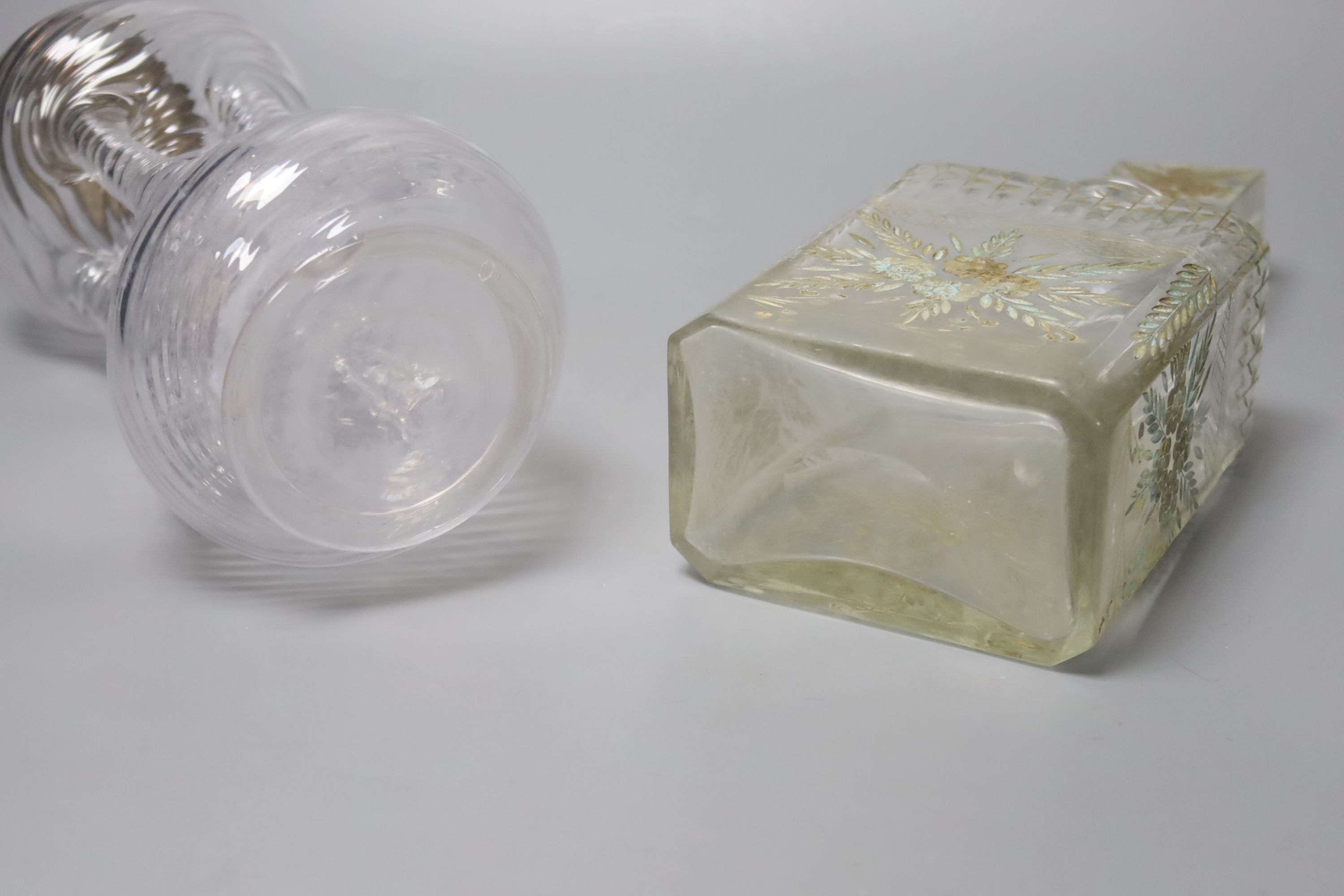 A Victorian wrythen moulded hour glass shaped decanter, with silver collar, 31cm high, togoether with a further 19th century engraved glass decanter (a.f.), 25cm high